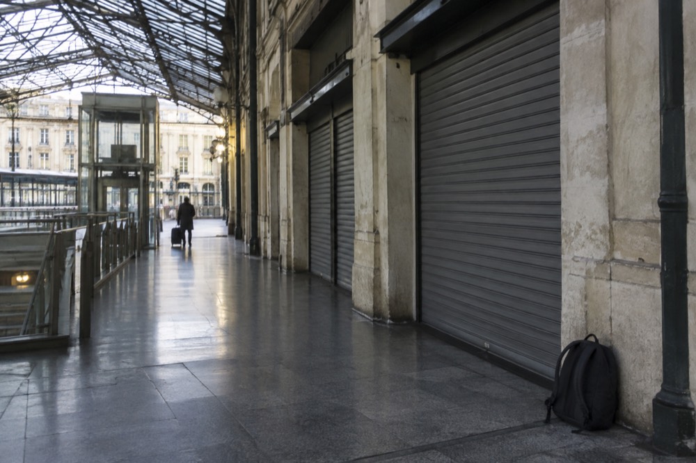 Empty station corridor with closed shutters and no locker bank in sight