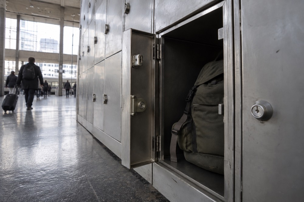 Une rangée de casiers à bagages en libre-service le long d'un mur dans une gare parisienne