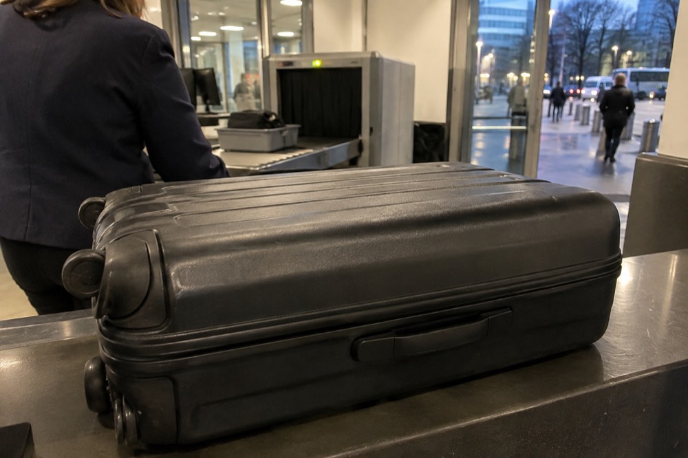 A suitcase on the counter of an airport left-luggage desk near Paris