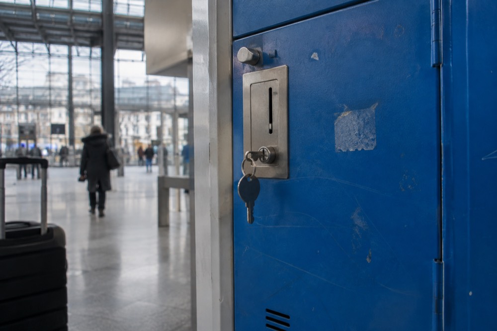 A close view of a SNCF luggage locker with a coin slot and a key